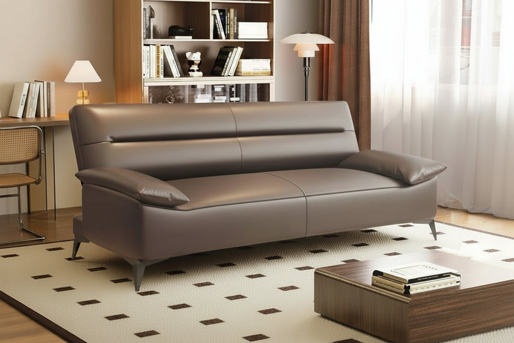 Brown leather sofa in a living room setting with furniture and decor.