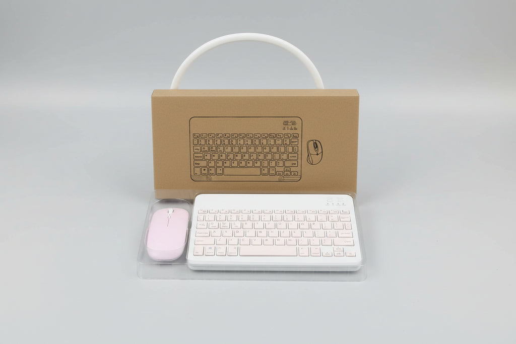 Wireless keyboard and mouse set with cardboard box on a light blue surface.