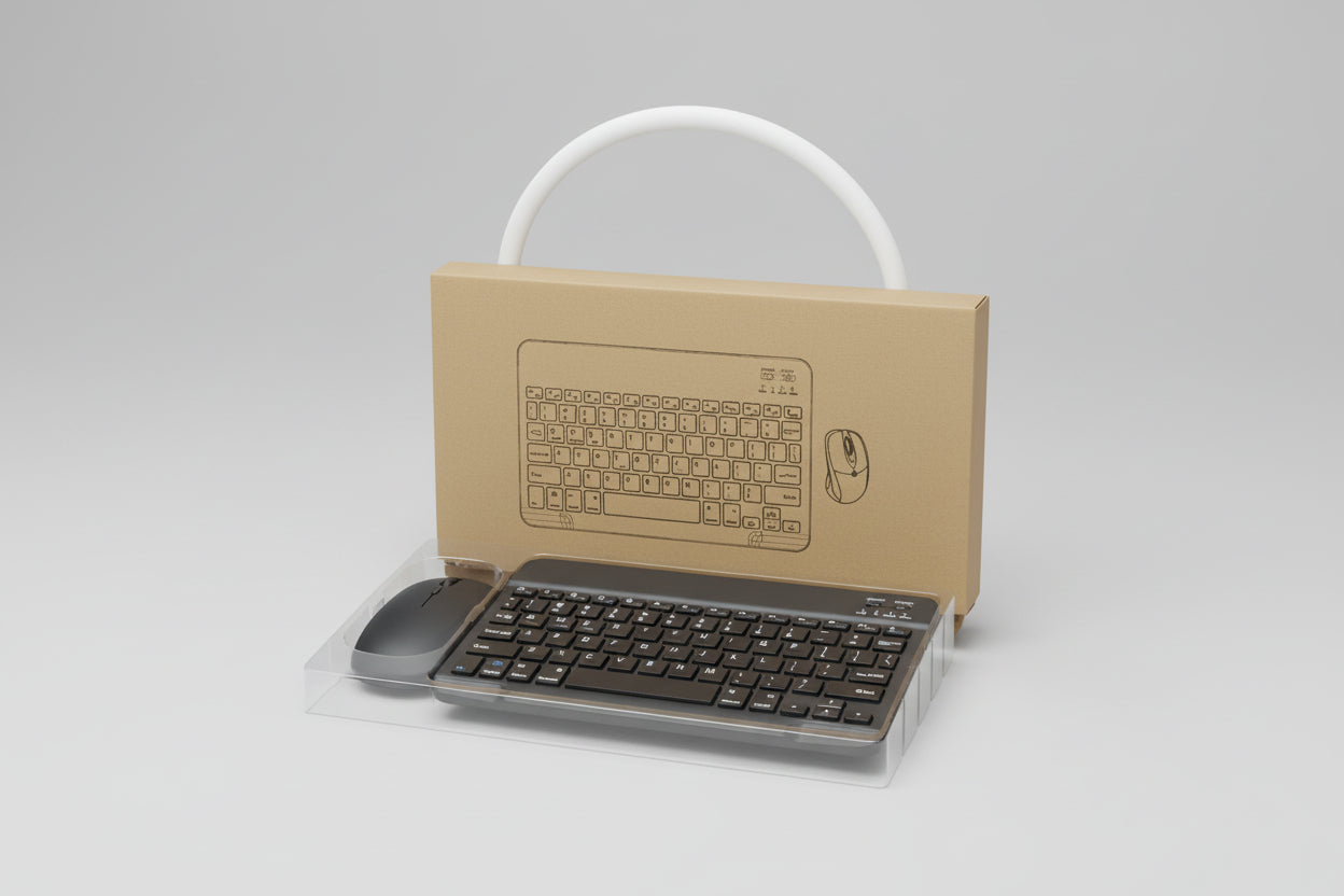 Cardboard cutout of a keyboard and mouse with a real keyboard and mouse on a surface.
