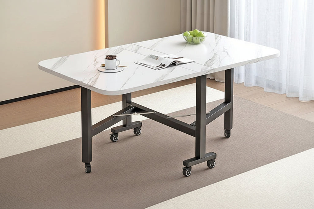 Foldable dining table with marble-like surface and wheels in a room setting.