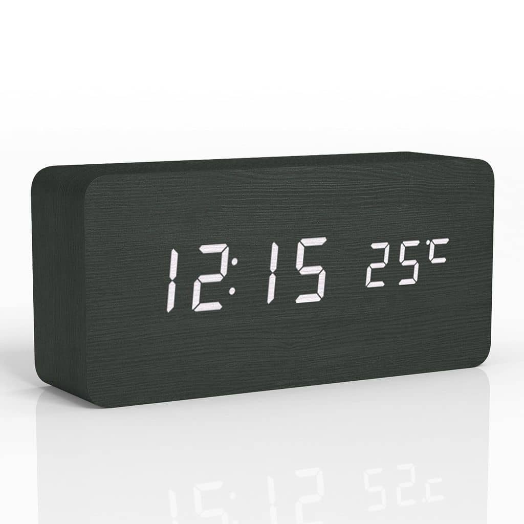 Black digital clock with white LED display on a white background