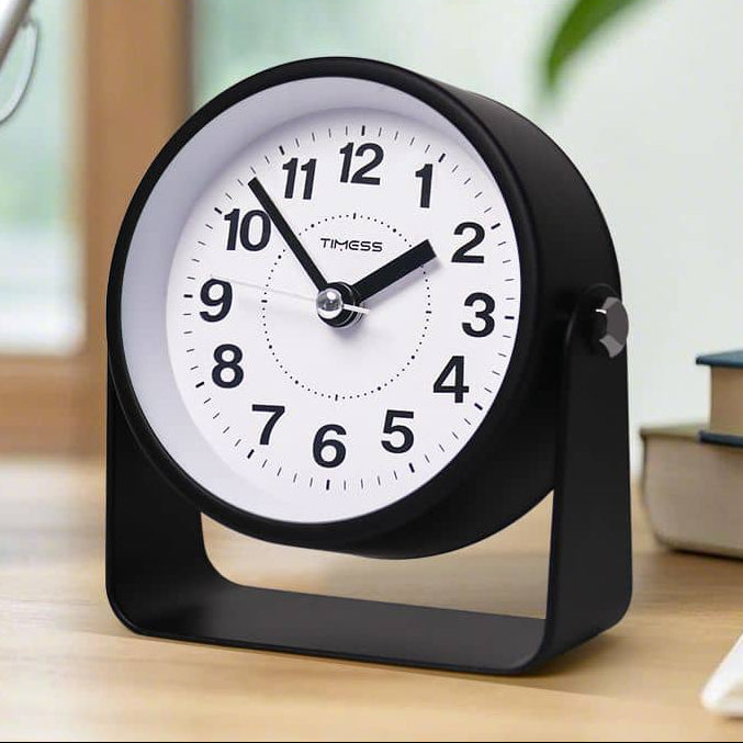 Black alarm clock on a wooden surface with text overlay