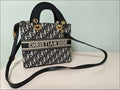 Christian Dior handbag with monogram pattern on a light background
