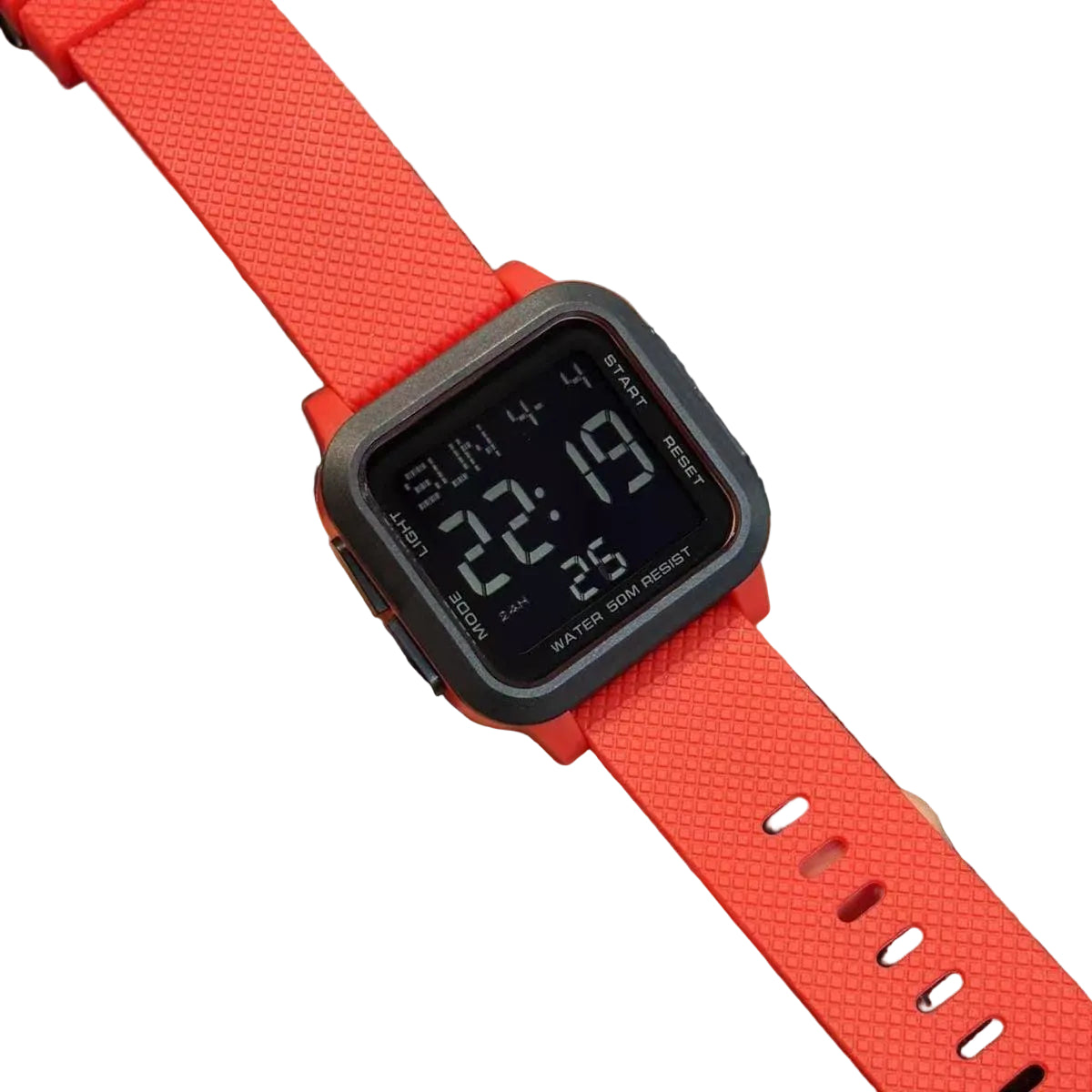 Digital watch with a red strap held in a hand on a dark background